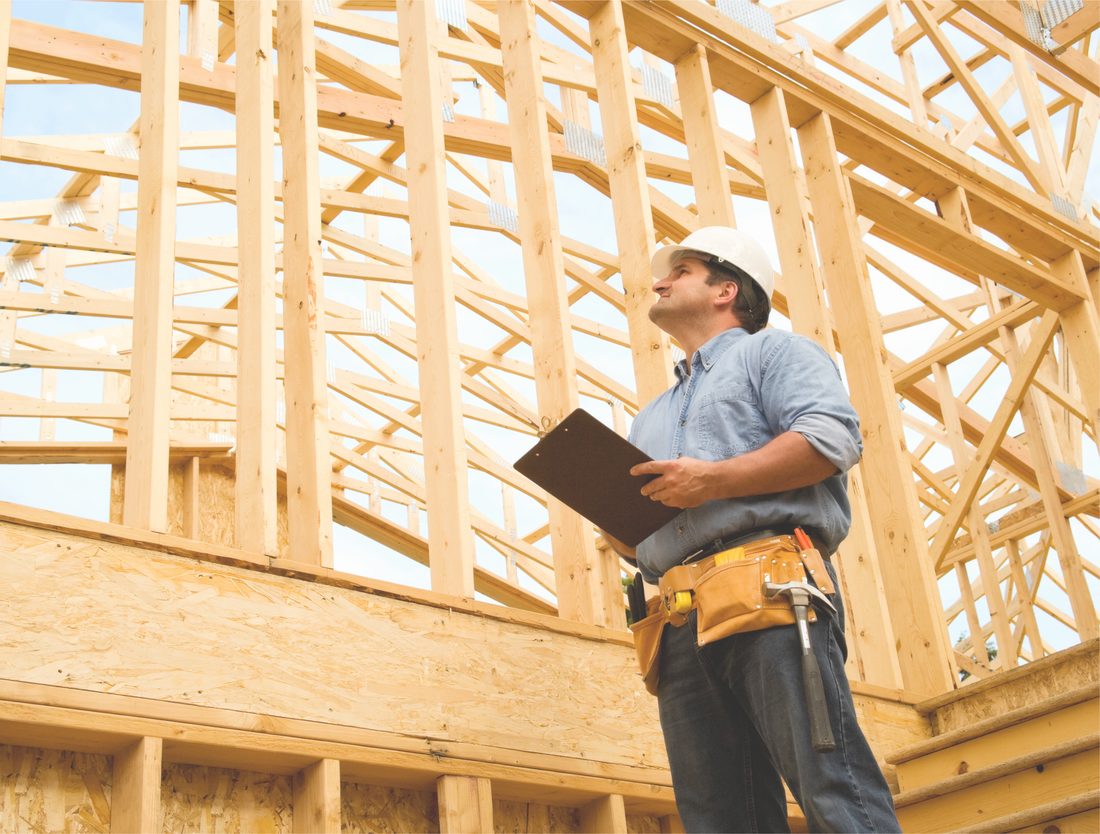 Contractor reviewing drawings on site during construction